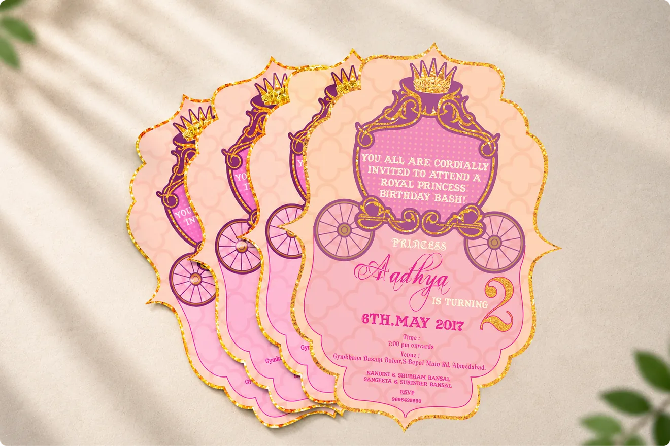 Aadhya 2nd birthday invitations shaped like a royal carriage, in pink and gold glitter
