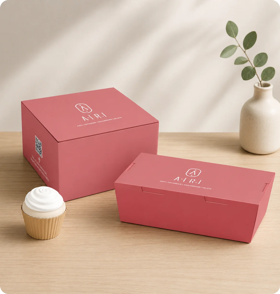 Pink Airi boxes with a small plant and cupcake