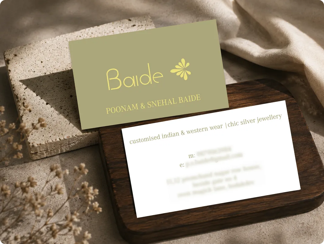 Baide Poshak and Sherwali Baide invitation card on a wooden surface