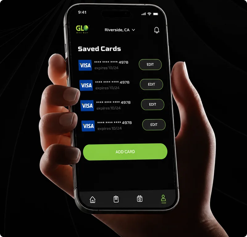 Hand holding a phone showing the GLO app saved cards screen