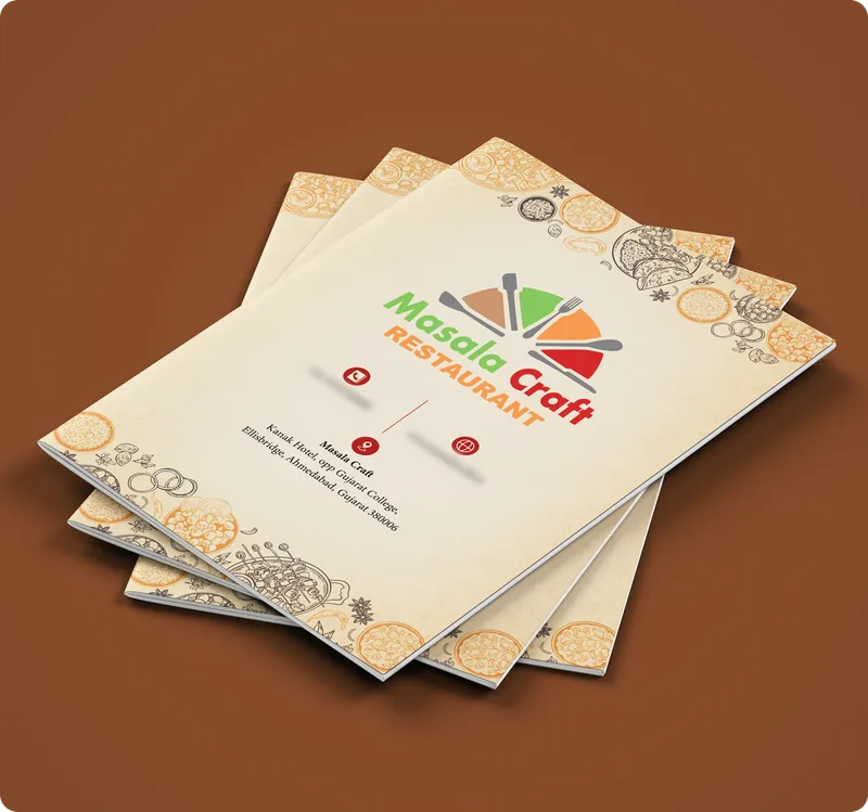 Stack of folded Masala Craft restaurant menus showing the cover logo and border pattern