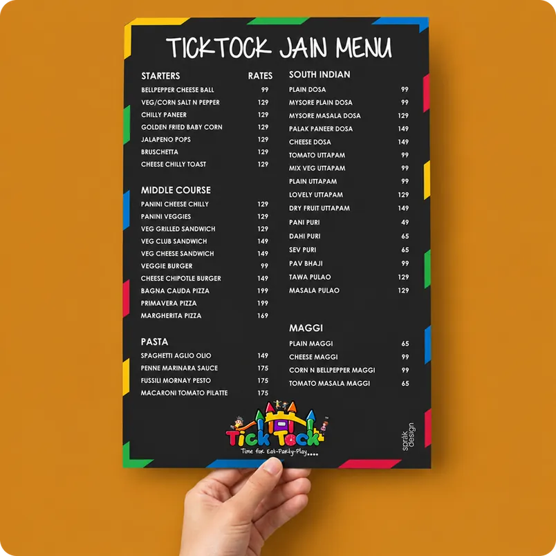 Hand holding the black Tick Tock Jain menu card
